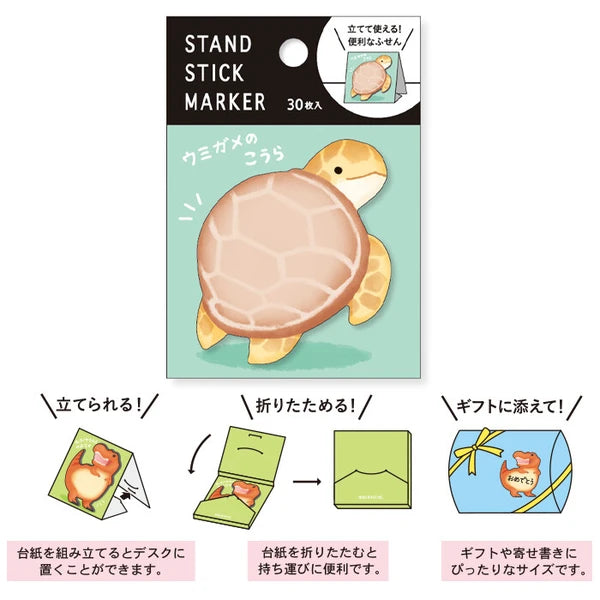 MIND WAVE Sea Turtle Koura sticky notes stand with colorful sticky note markers in a clear holder on a desk.