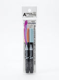 Two JapanoMono alcohol ink markers in blue, yellow, and gray, shown with vibrant ink tips for art and craft projects.