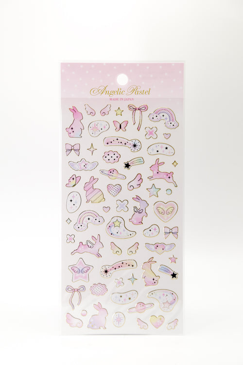 Pastel celestial stickers featuring winged bunnies, ribbons, and shooting stars by JapanoMono, perfect for decorating notebooks or crafts.
